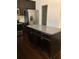 Kitchen island featuring dark wood cabinets and granite countertops at 5671 Radford Loop, Fairburn, GA 30213