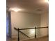 Upstairs landing with neutral carpet and a railing at 5671 Radford Loop, Fairburn, GA 30213