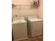 Bright laundry room with full-size washer and dryer, plus wire shelf at 5671 Radford Loop, Fairburn, GA 30213
