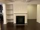 Cozy living room featuring a fireplace with built-in shelving at 5671 Radford Loop, Fairburn, GA 30213