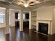 Bright living room with a fireplace, built-in shelves, and coffered ceiling at 5671 Radford Loop, Fairburn, GA 30213