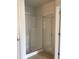 Bathroom featuring a shower with glass door at 5671 Radford Loop, Fairburn, GA 30213