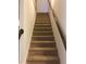 Carpeted staircase with wooden handrails for comfortable and safe access at 5671 Radford Loop, Fairburn, GA 30213