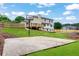 Large backyard with sports court, grassy areas, deck, and privacy fence at 2015 Clipper Straits, Snellville, GA 30078