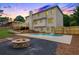 Backyard with in-ground pool, fire pit, and deck at dusk at 2015 Clipper Straits, Snellville, GA 30078