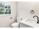 Bathroom including toilet, sink, vanity with matte black hardware, and window at 2015 Clipper Straits, Snellville, GA 30078