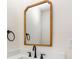 Close up of bathroom vanity with black faucet and towel ring with a gold trimmed mirror at 2015 Clipper Straits, Snellville, GA 30078