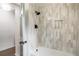 Beautiful bathroom showcasing a shower with light stone tiling and matte black hardware at 2015 Clipper Straits, Snellville, GA 30078