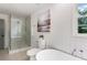 Bright bathroom with a glass shower, free standing tub, and modern fixtures at 2015 Clipper Straits, Snellville, GA 30078
