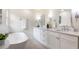 Bright bathroom with white vanity and a soaking tub at 2015 Clipper Straits, Snellville, GA 30078