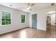 Bedroom with hardwood floors, windows, and a gray door at 2015 Clipper Straits, Snellville, GA 30078
