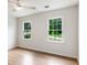 Bright bedroom with hardwood floors, ceiling fan, and windows looking out to green space at 2015 Clipper Straits, Snellville, GA 30078