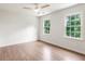 Bright bedroom with hardwood floors, ceiling fan, and natural light from the windows at 2015 Clipper Straits, Snellville, GA 30078