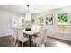 Dining room with hardwood floors, decorative lighting, and a six-chair table at 2015 Clipper Straits, Snellville, GA 30078