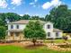 Beautiful two-story home featuring white painted brick, a welcoming front porch, and a serene water feature at 2015 Clipper Straits, Snellville, GA 30078
