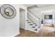 Bright foyer showcasing hardwood floors, staircase with white railing, and stylish round mirror at 2015 Clipper Straits, Snellville, GA 30078