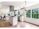 Bright eat-in kitchen with white cabinets, stainless steel appliances, and hardwood floors at 2015 Clipper Straits, Snellville, GA 30078