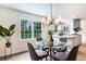 Eat-in kitchen featuring hardwood floors, a glass-top table, and stainless steel appliances at 2015 Clipper Straits, Snellville, GA 30078