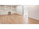 Spacious living room with hardwood floors and built in shelving with a view into the entryway at 2015 Clipper Straits, Snellville, GA 30078