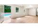 Large living room with hardwood floors and French doors that lead to the outdoor pool area at 2015 Clipper Straits, Snellville, GA 30078
