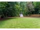 Expansive backyard featuring lush green grass and a storage shed, fully fenced at 2617 Warwick Ne Cir, Atlanta, GA 30345