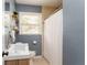 Bathroom with walk-in shower, sleek vanity, and shelving at 2617 Warwick Ne Cir, Atlanta, GA 30345