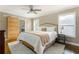 Spacious bedroom features neutral walls, ceiling fan, and a sliding barn door to the ensuite bath at 2617 Warwick Ne Cir, Atlanta, GA 30345