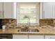 Kitchen sink area with granite countertops and a view of the backyard at 2617 Warwick Ne Cir, Atlanta, GA 30345