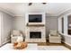 Living room showcasing fireplace with mantel, seating arrangement, and picture window at 2617 Warwick Ne Cir, Atlanta, GA 30345