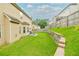 Large, grassy backyard with a stone retaining wall and a privacy fence, ideal for activities at 3869 Maiden Fern Ln, Snellville, GA 30039