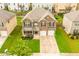 Beautiful two-story brick home featuring a manicured front lawn, complemented by an attached two-car garage at 3869 Maiden Fern Ln, Snellville, GA 30039