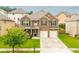 Charming two-story brick home with a well-manicured lawn and two-car garage, perfect for a growing Gathering at 3869 Maiden Fern Ln, Snellville, GA 30039