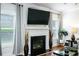 Stylish fireplace with a mounted TV, complemented by elegant decor, creating a cozy ambiance at 3869 Maiden Fern Ln, Snellville, GA 30039