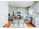 Kitchen features gray cabinets, stainless steel appliances, and granite countertops at 3869 Maiden Fern Ln, Snellville, GA 30039
