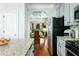 View from the kitchen into the dining room and living room, showcasing the open layout at 3869 Maiden Fern Ln, Snellville, GA 30039