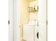Efficient laundry area with a washer and dryer, maximizing space with shelving at 3869 Maiden Fern Ln, Snellville, GA 30039