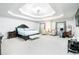 Spacious primary suite with tray ceilings, sitting area, and ample natural light at 3869 Maiden Fern Ln, Snellville, GA 30039