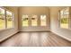 Sun-drenched room featuring wood floors and three windows offering an abundance of natural light at 670 Park Place Way, Social Circle, GA 30025