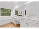 Bright bathroom with dual vanity, soaking tub, and large window overlooking trees at 1575 Wynridge Pointe, Alpharetta, GA 30005