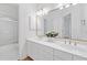 Bright bathroom featuring a dual vanity, large mirror, and tile floor at 1575 Wynridge Pointe, Alpharetta, GA 30005