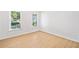 Bright, empty bedroom with wood-look floor and views of the neighborhood outside at 1575 Wynridge Pointe, Alpharetta, GA 30005