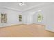Bright, empty bedroom offers a tray ceiling, natural light, and wood-look flooring at 1575 Wynridge Pointe, Alpharetta, GA 30005