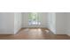 Bedroom featuring hardwood floors, a large window, and a bright, airy feel at 1575 Wynridge Pointe, Alpharetta, GA 30005