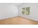 Empty bedroom with light wood floor and a window with blinds at 1575 Wynridge Pointe, Alpharetta, GA 30005