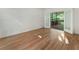 Sunlit bedroom with hardwood floors and access to a private deck at 1575 Wynridge Pointe, Alpharetta, GA 30005