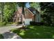 Brick home with a well-maintained lawn, mature trees, and a convenient two-car garage at 1575 Wynridge Pointe, Alpharetta, GA 30005