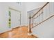 Bright foyer with hardwood floors, a staircase, and a glass front door at 1575 Wynridge Pointe, Alpharetta, GA 30005