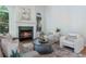 Cozy living room features a fireplace, plush seating, and bright natural light at 1575 Wynridge Pointe, Alpharetta, GA 30005