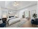 Spacious main bedroom boasts vaulted ceilings and an accent chair at 1575 Wynridge Pointe, Alpharetta, GA 30005