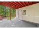 Exterior patio area featuring a painted red beam ceiling with access to the yard at 1575 Wynridge Pointe, Alpharetta, GA 30005